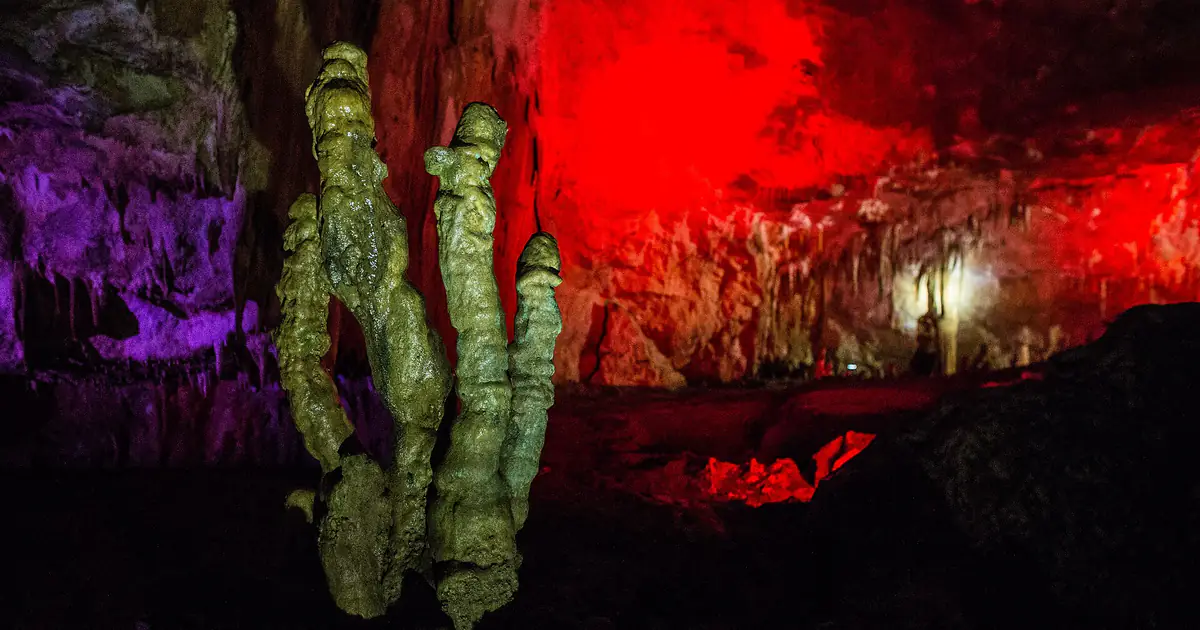 Stalagmites under coloured lights in Prometheus Cave