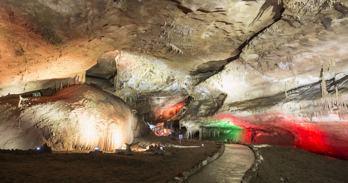 Lit hall and walkway inside the cave